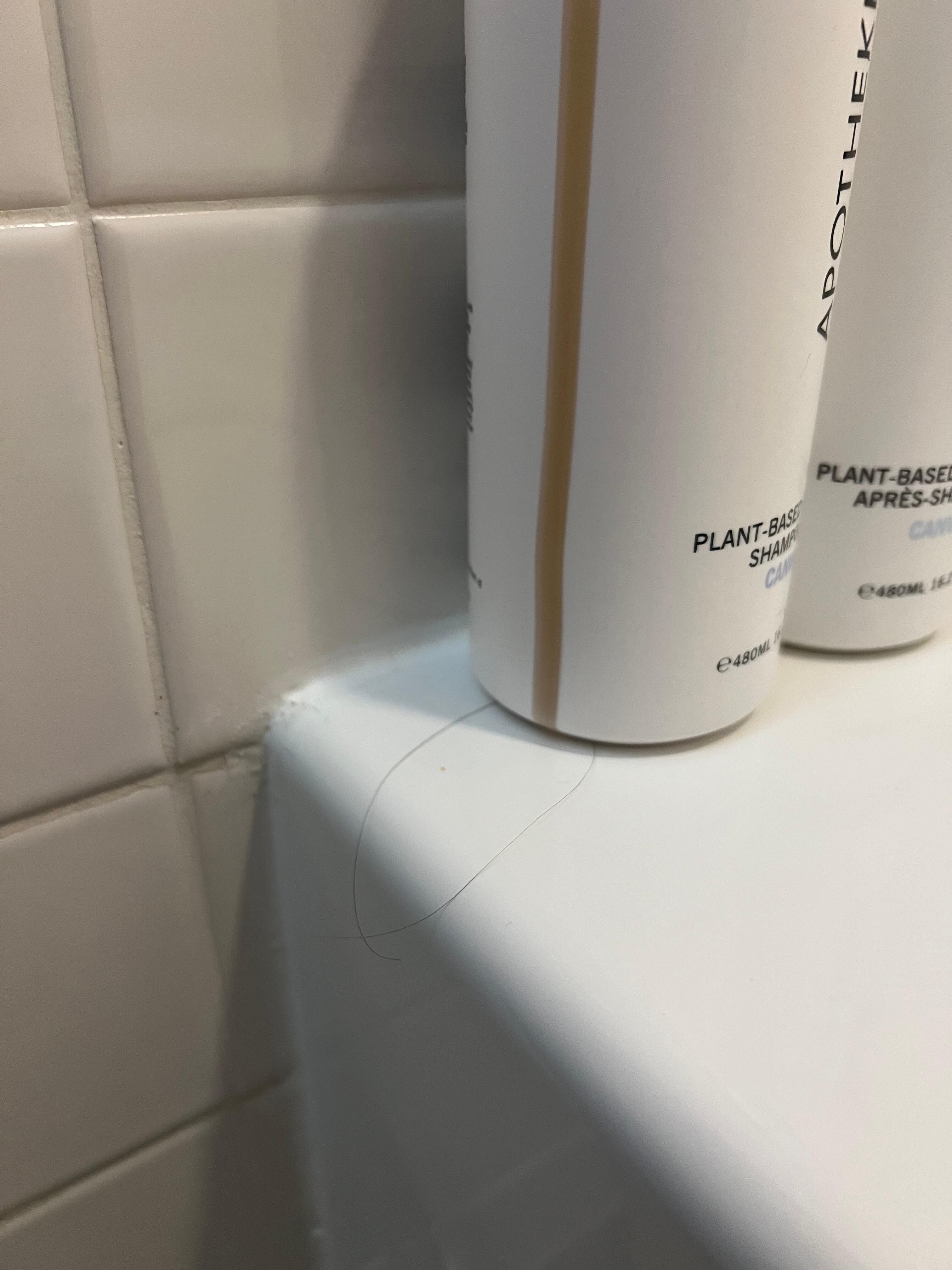 Hair all over bathroom: in tub, toilet and sink