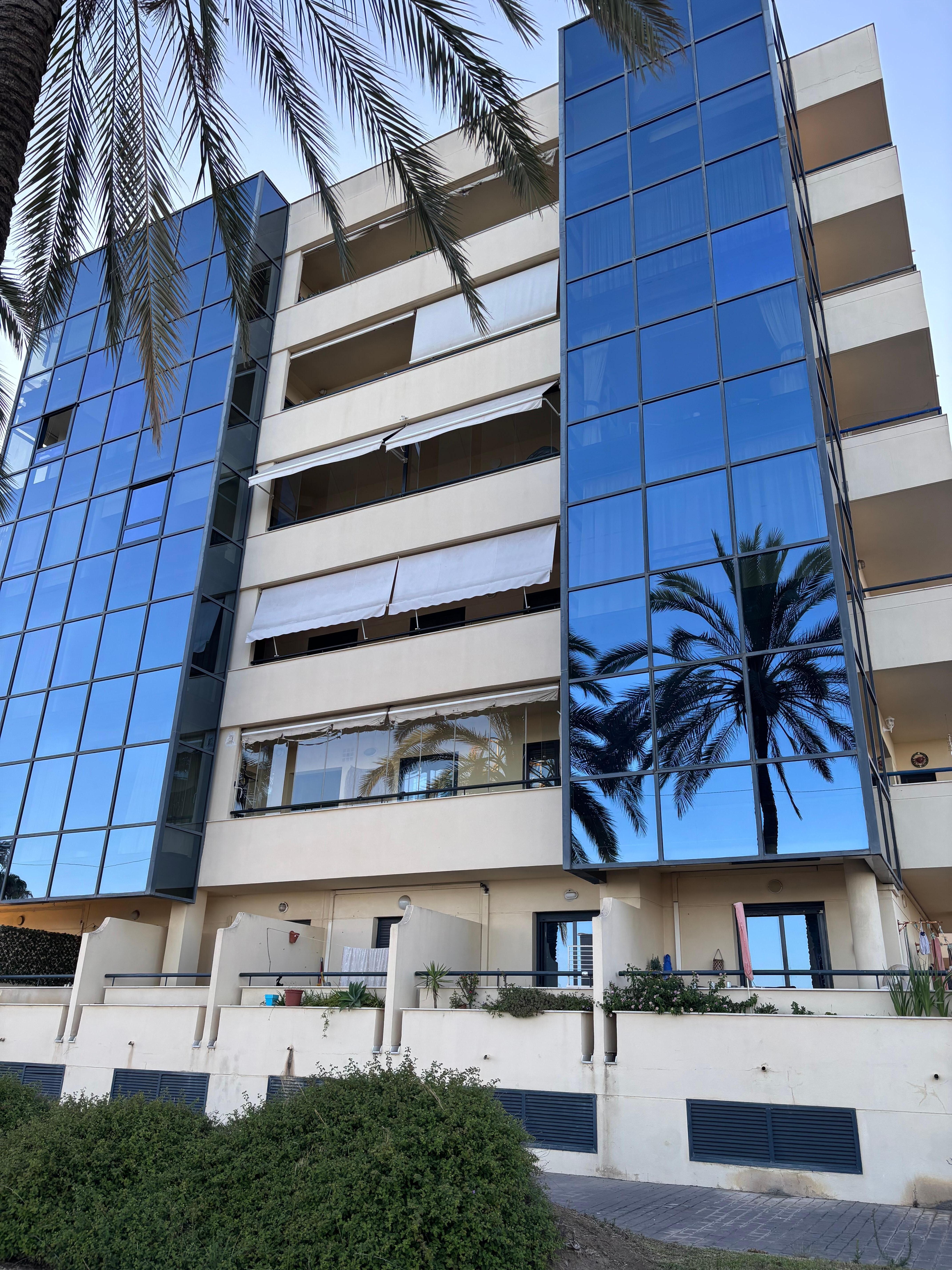 Living room is behind tinted glass, balcony is in between tinted glasses on 4th floor