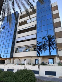 Living room is behind tinted glass, balcony is in between tinted glasses on 4th floor