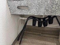 broken luggage cart and piece of cardboard blocking tissue dispenser