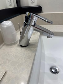 Sink faucet is just sitting on the vanity top. It isn’t attached.