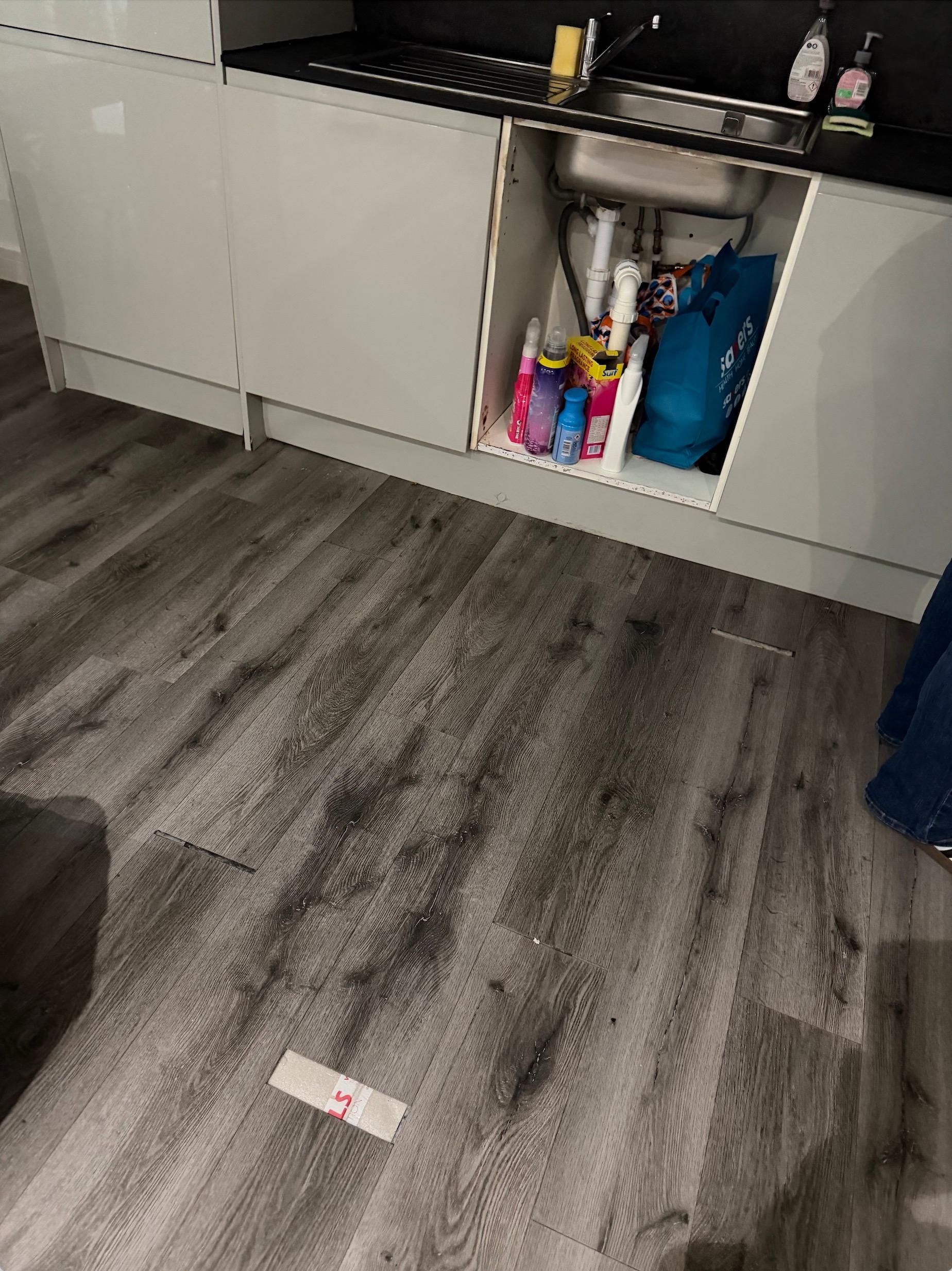 Really bad flooring job, gaps everywhere and missing cabinet door