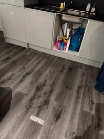 Really bad flooring job, gaps everywhere and missing cabinet door
