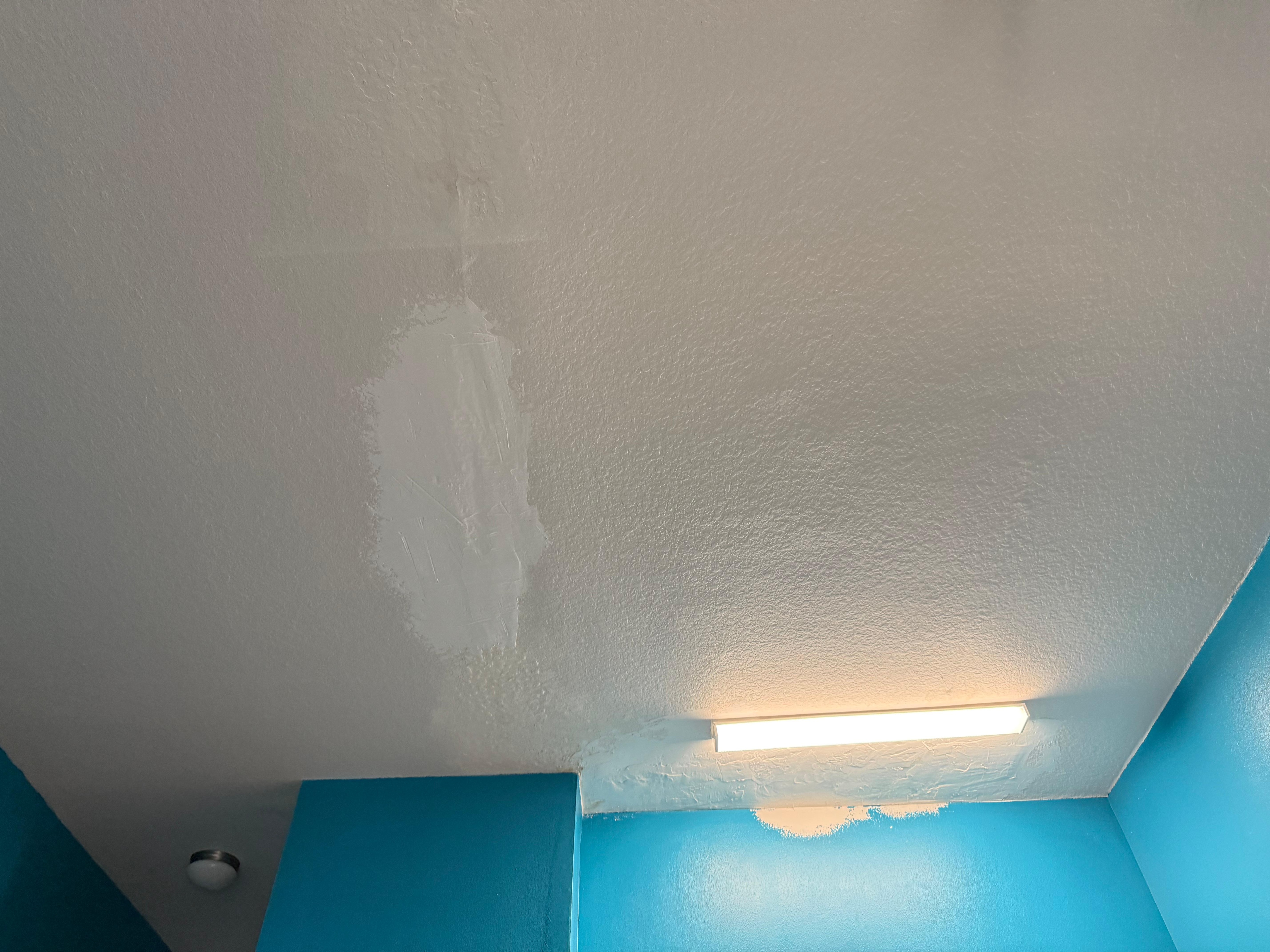 Ugly ceiling with patches in different
 paint colors  