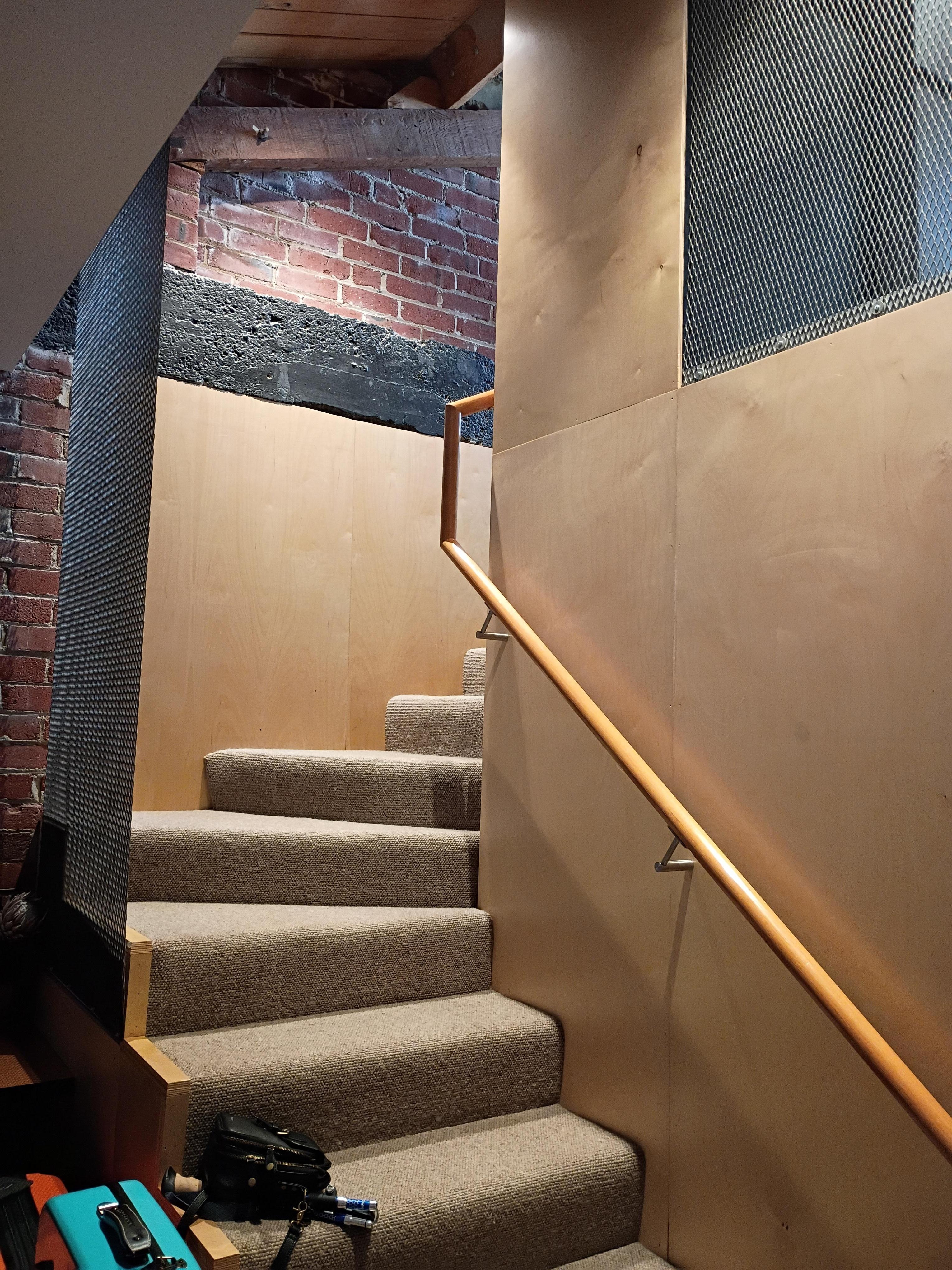 Stairs leading up to the kitchen / living room spaces