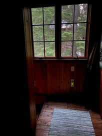 Sweet large window at the top of the stairs, beautiful old cabin wooden floors. Owner must care so much about this home.