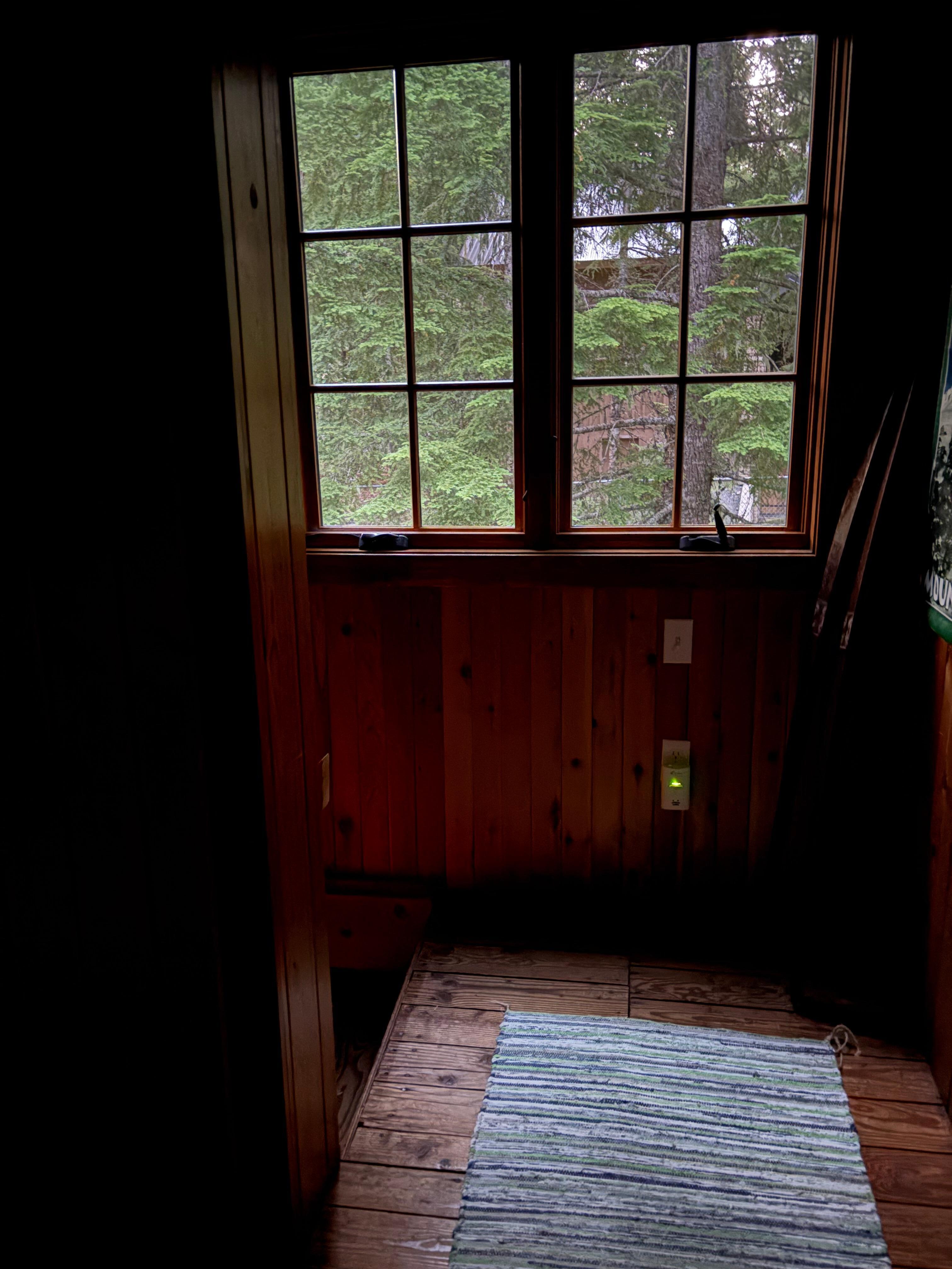 Sweet large window at the top of the stairs, beautiful old cabin wooden floors. Owner must care so much about this home. 