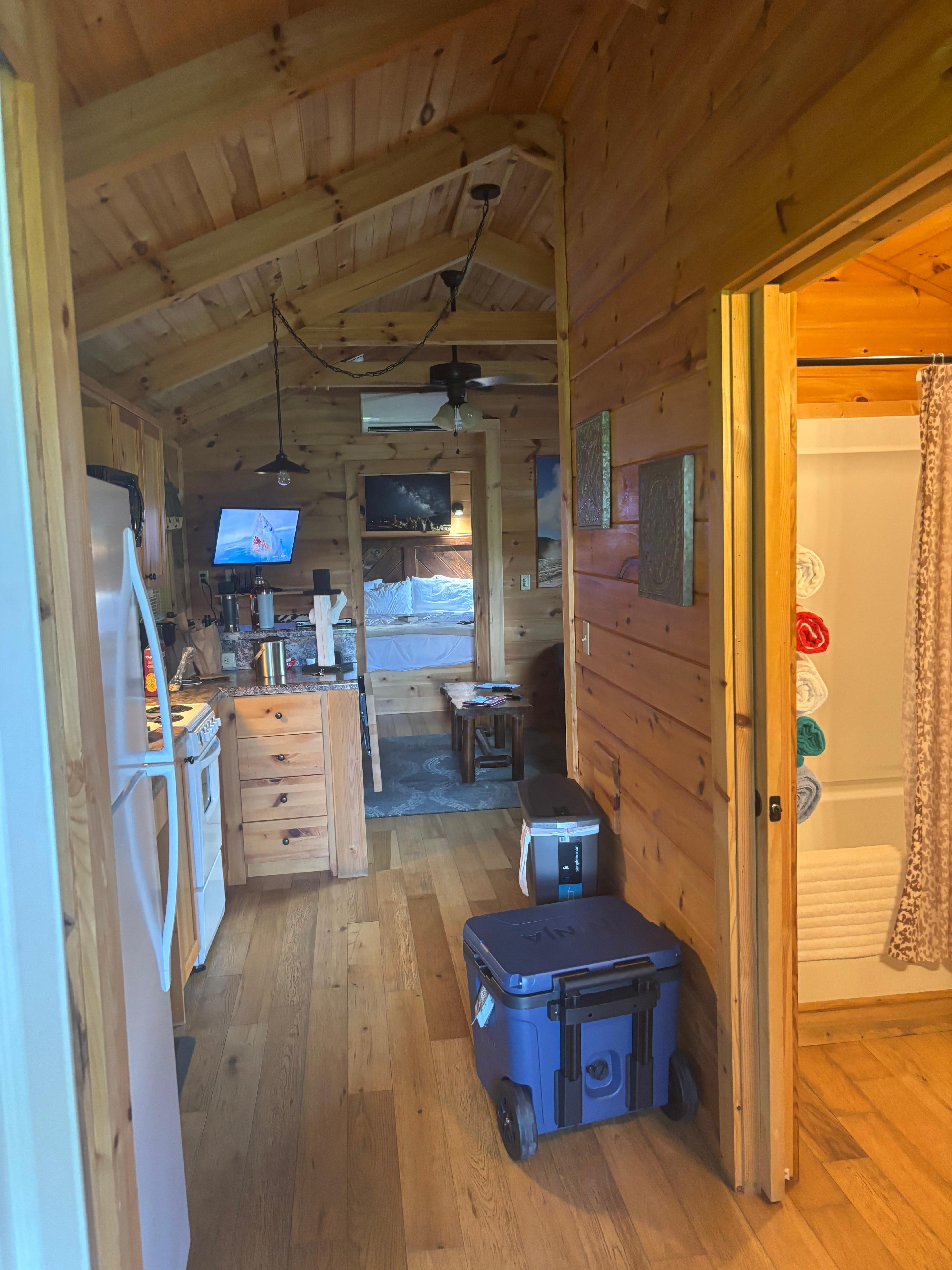 View from doorway into cabin at kitchen door from side covered deck . 👍