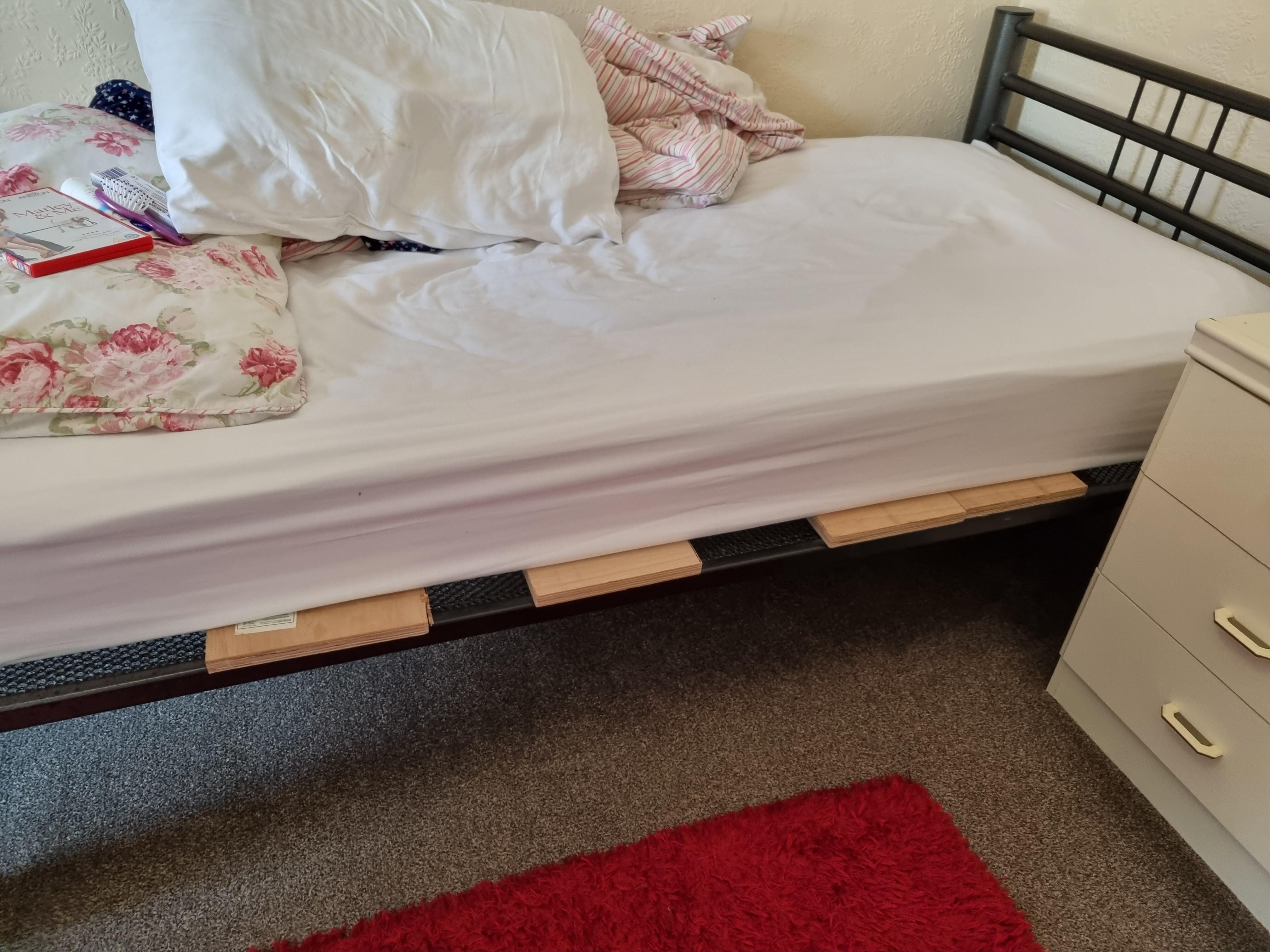 Plywood boards sticking out below mattress