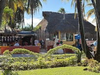 entrance with security and small farmacia across road