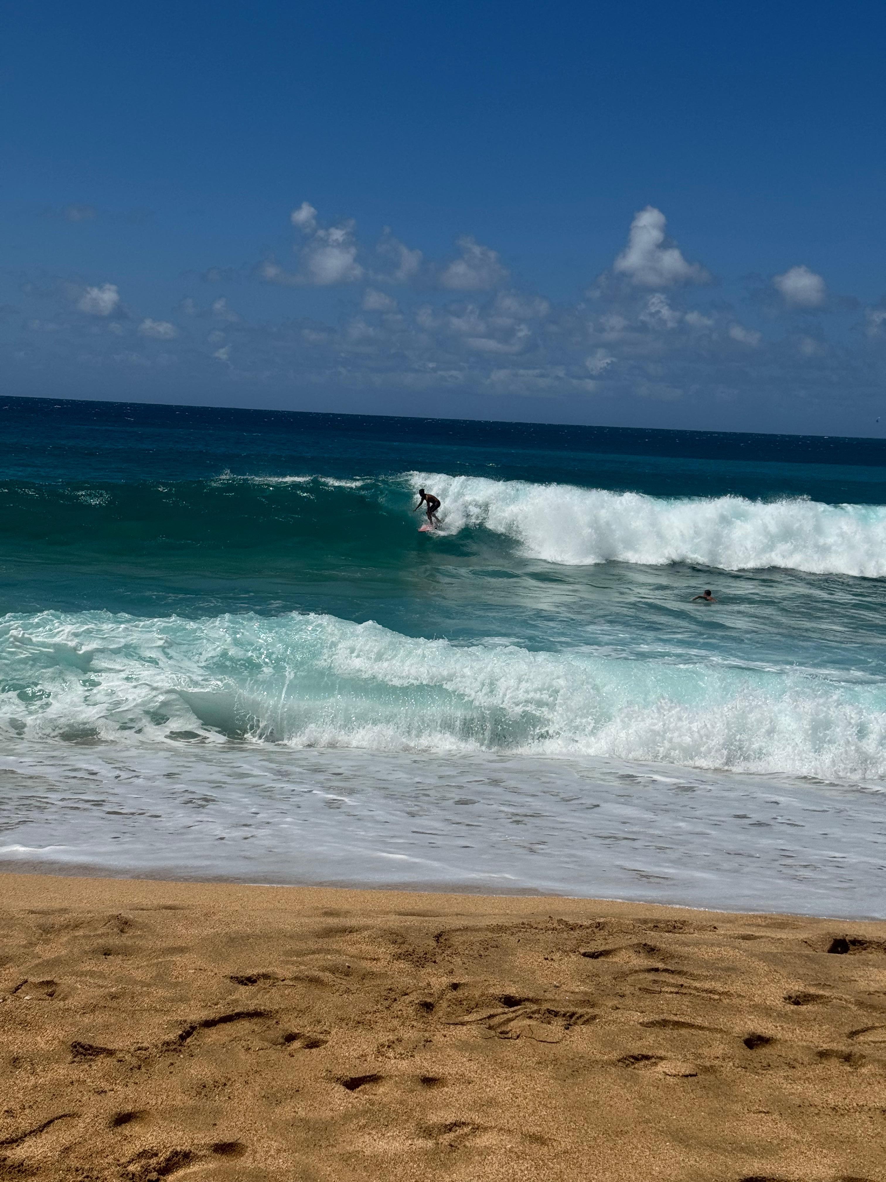 Surfer tunnels beach