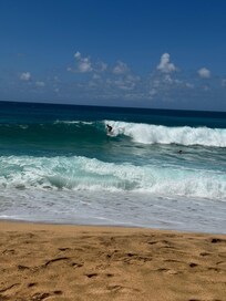 Surfer tunnels beach