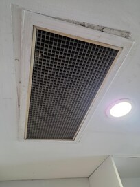 The air vent is full of dust, clearly showing that it has never been cleaned.