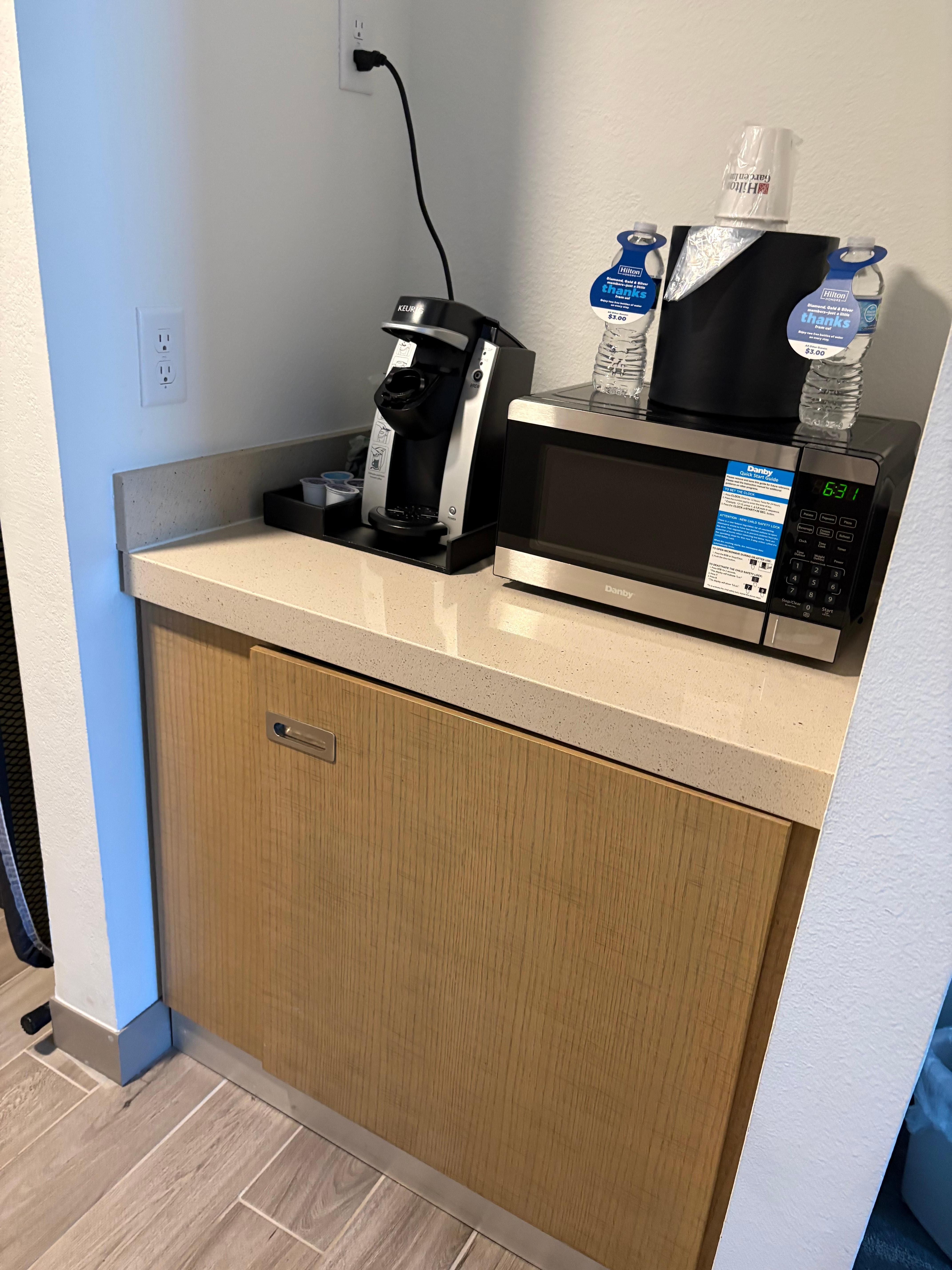 Keurig, microwave, mini fridge in cabinet 