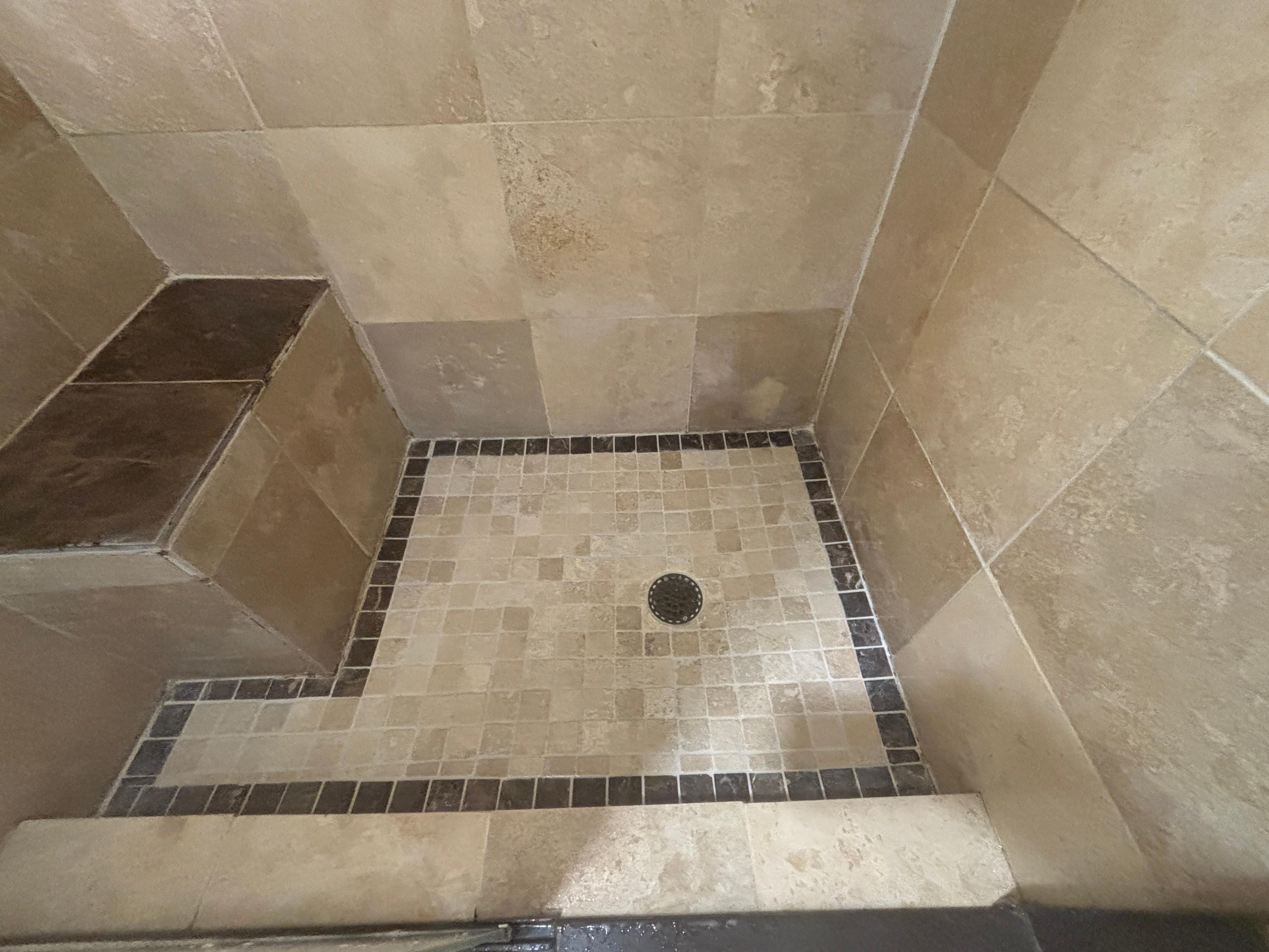 Sharp corners in master shower, with aggressive slope to shower pan. 