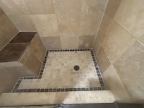 Sharp corners in master shower, with aggressive slope to shower pan.