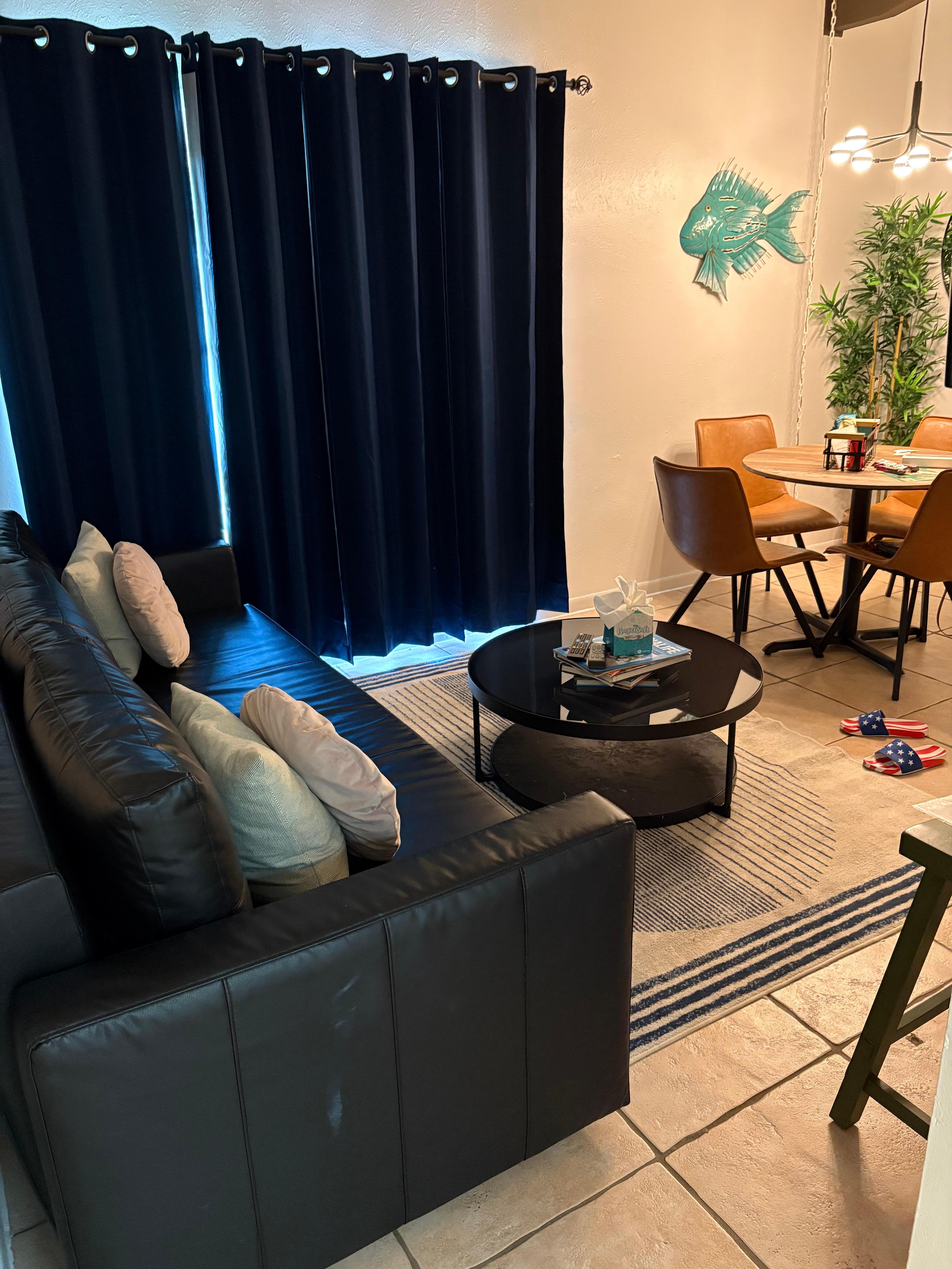 Living room with dining space between it and the front door. 