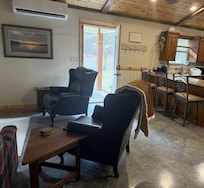 From living room looking toward kitchen. Two recliners, sofa, and Smart TV.