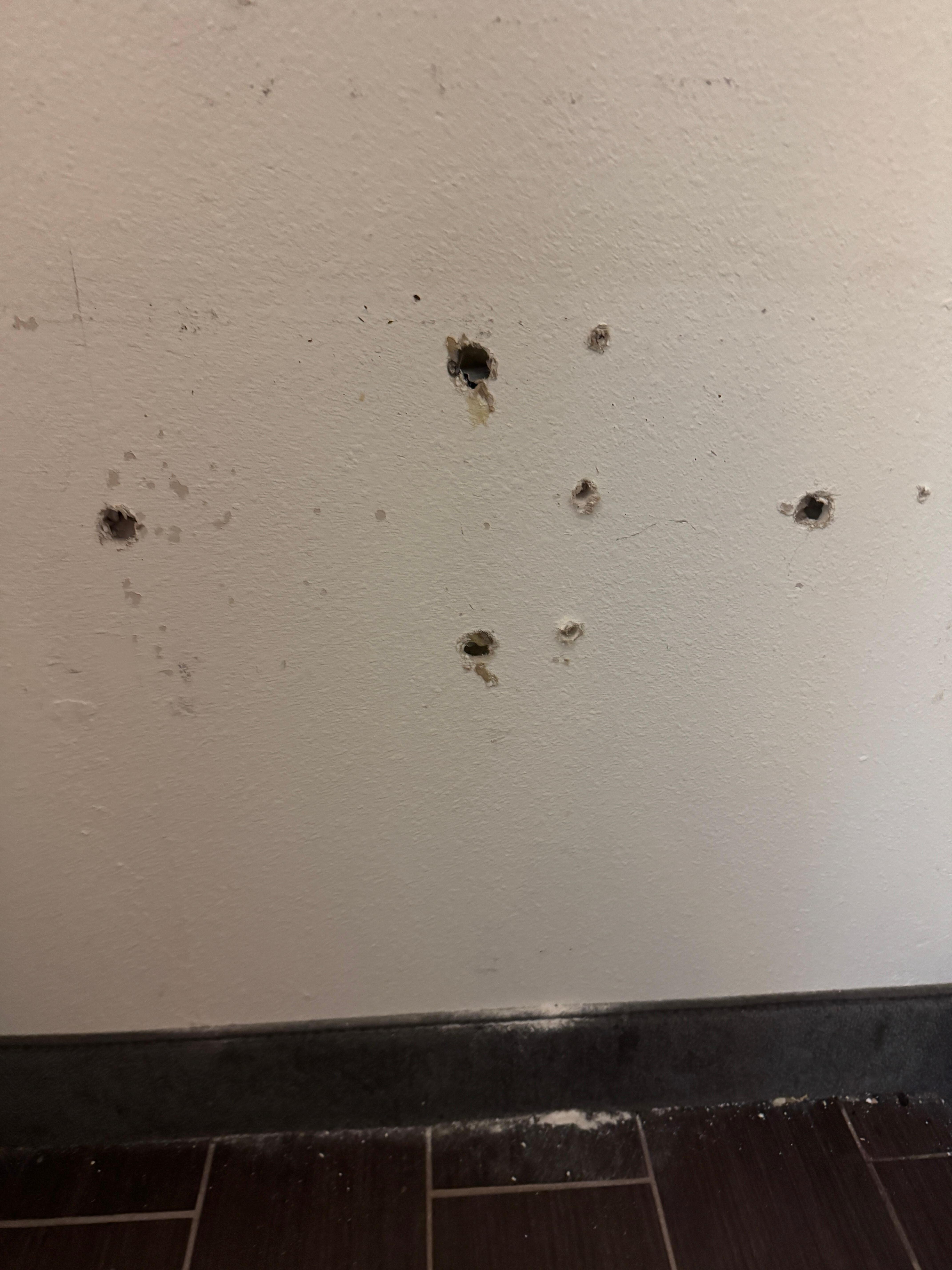 Holes in the wall from the safe being ripped out. 