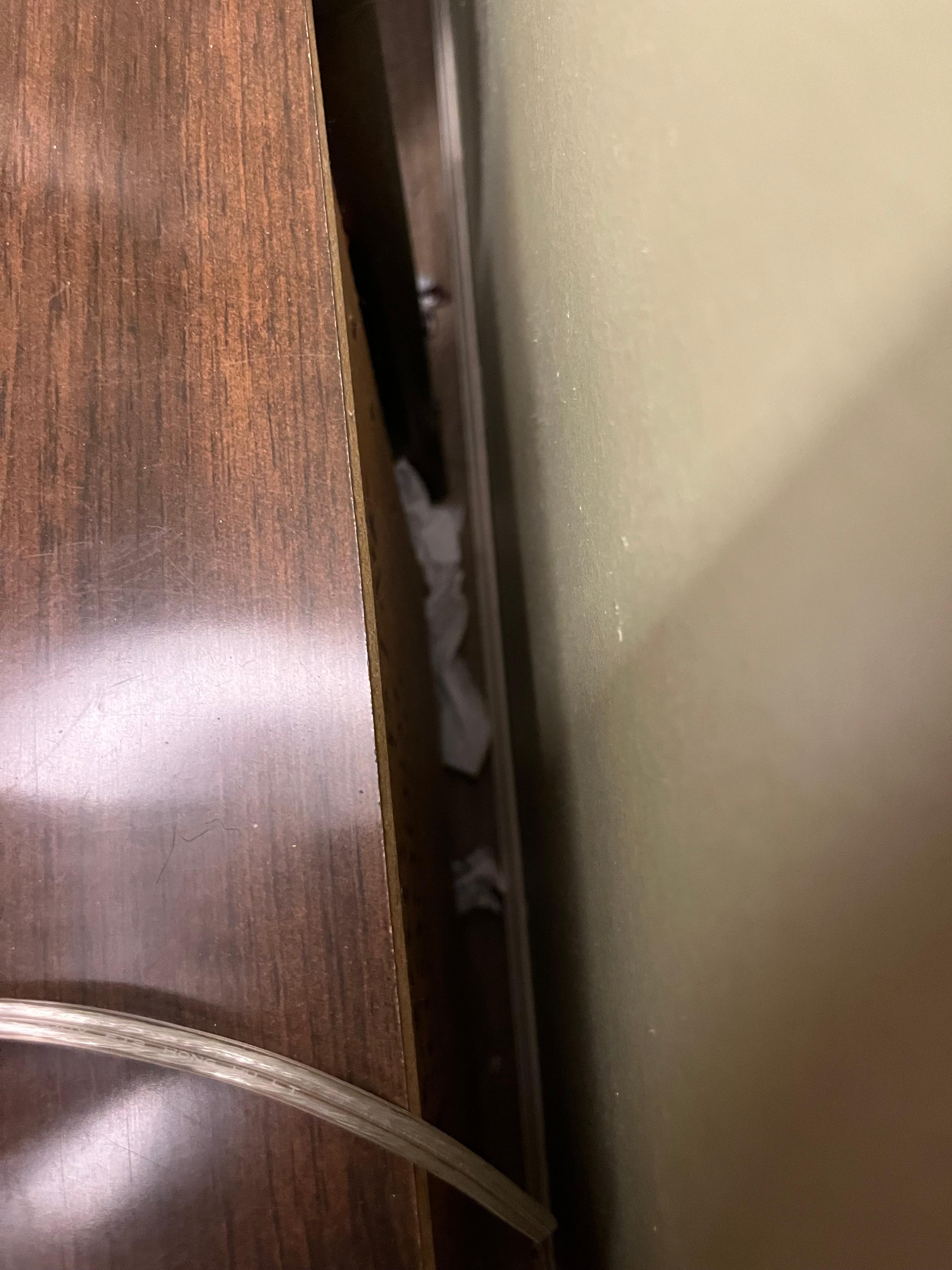 Dirty tissues behind nightstand in master bedroom 