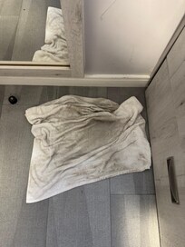 A towel I used to roughly wipe the floor after the room had been cleaned and the floor cleaned twice.
