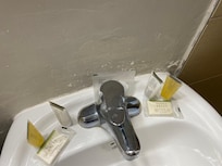 Extremely beat up wall by the sink area