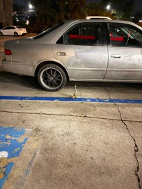 Beer bottles and broken down cars in front of the lobby