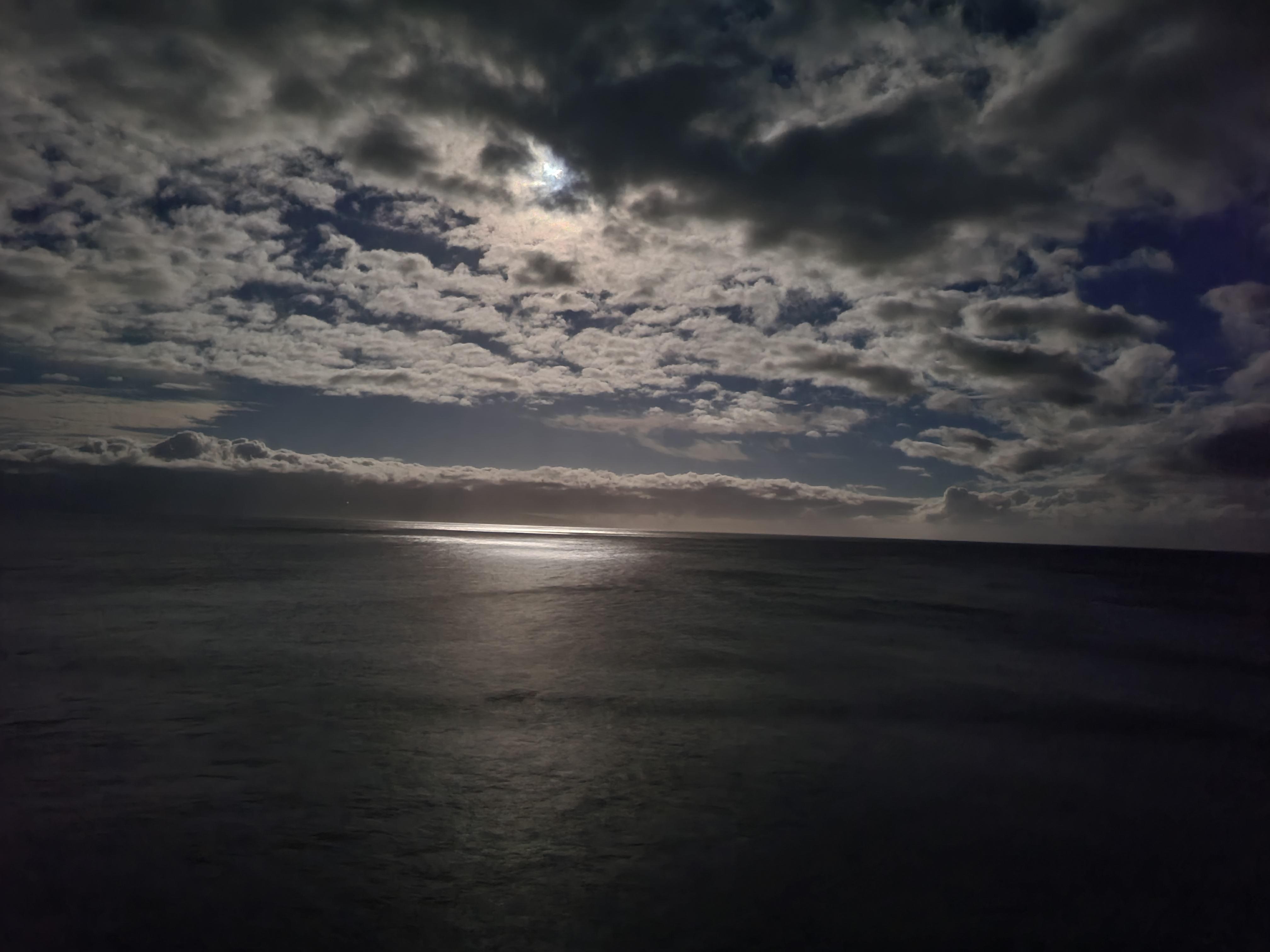 Moon peaking through the clouds.  Taken from the balcony.