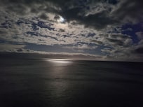 Moon peaking through the clouds. Taken from the balcony.