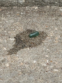 One of many pills on sidewalk
