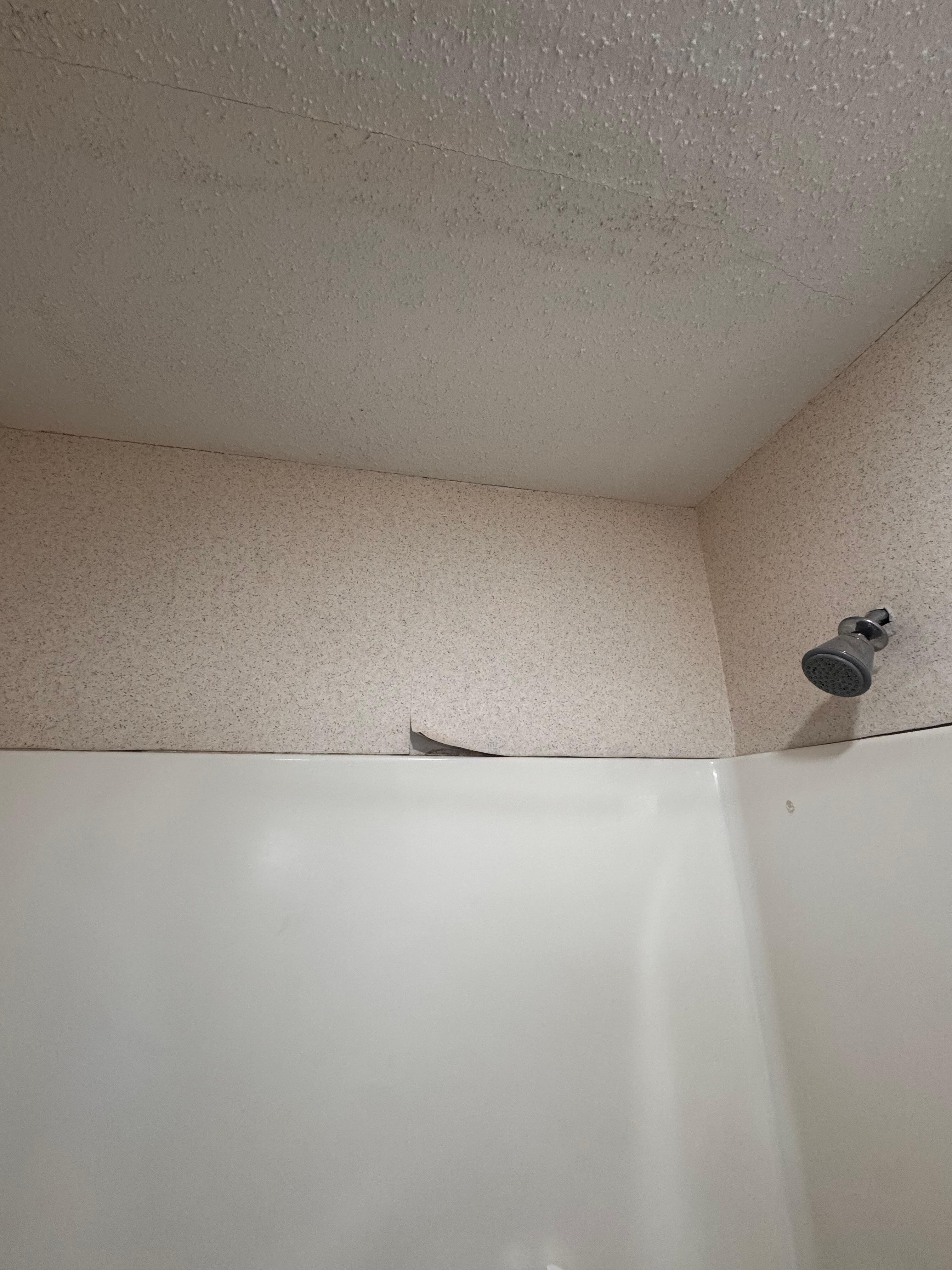 Peeling wallpaper in bathroom