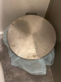 Bathroom garbage can lid filthy. We took this as a clear example of how dirty the house was. All of the floors were dirty but the photos we took couldn't show this well. We had to carefully select only 8 photos to post as that is the max. allowed