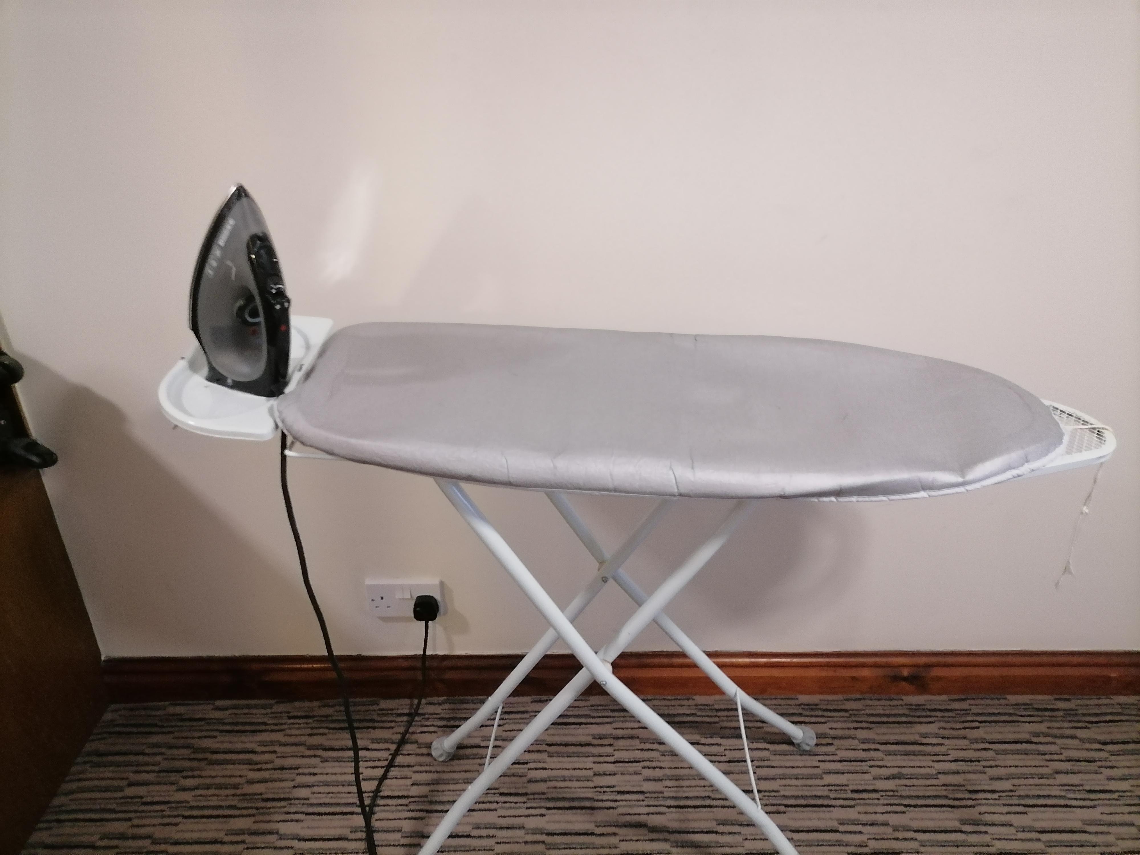 Ironing board with cover that did not fit on. 