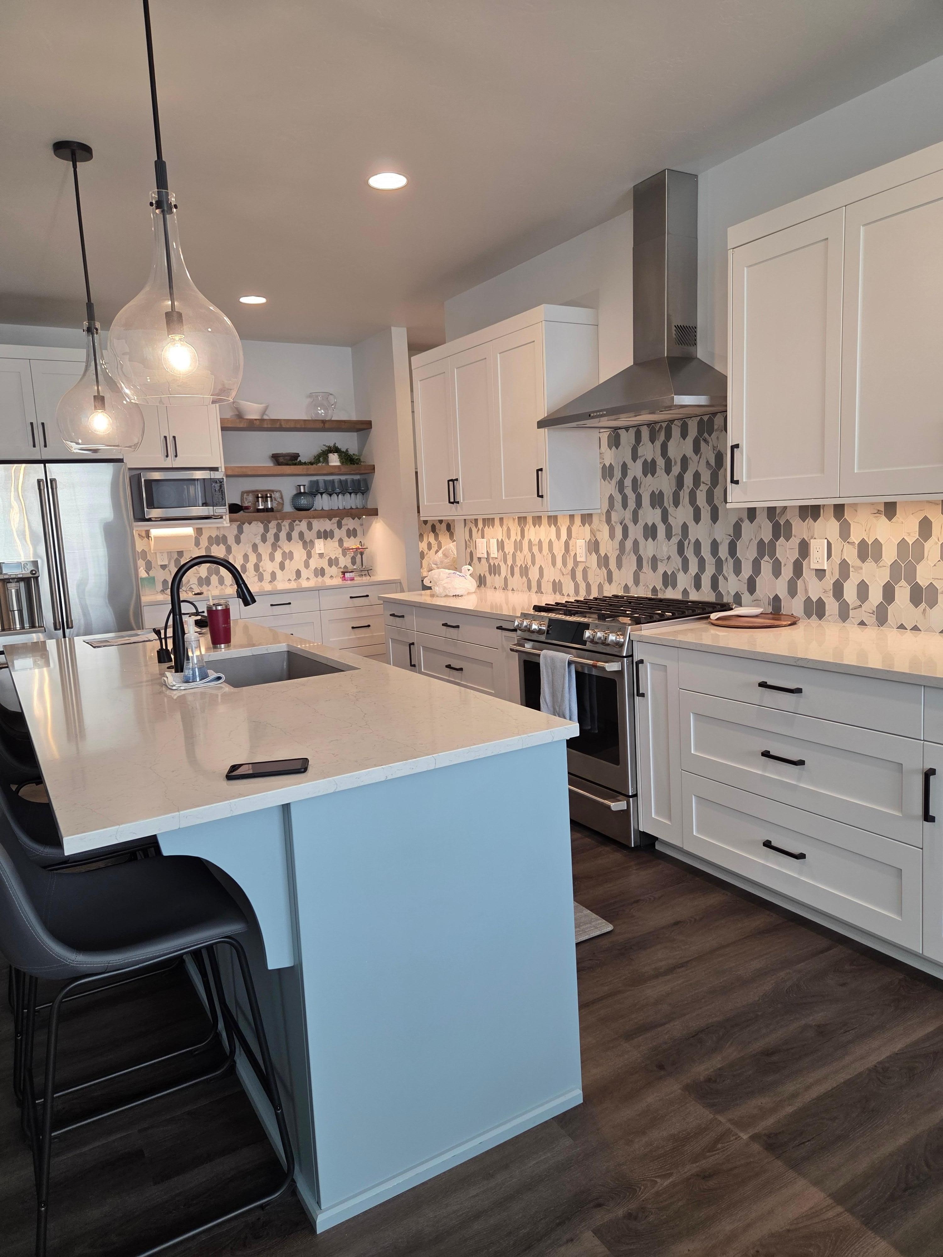 Kitchen with high end appliances and Island with Laundry room right around the corner next to three car garage entrance