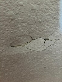 Hole in the wall by the bed