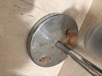 The bottom of the toilet roll and brush holder