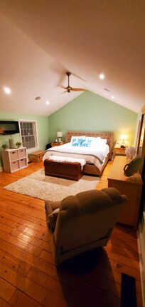 This spacious main bedroom has an insanely comfy king bed to sink into at the end of the day!