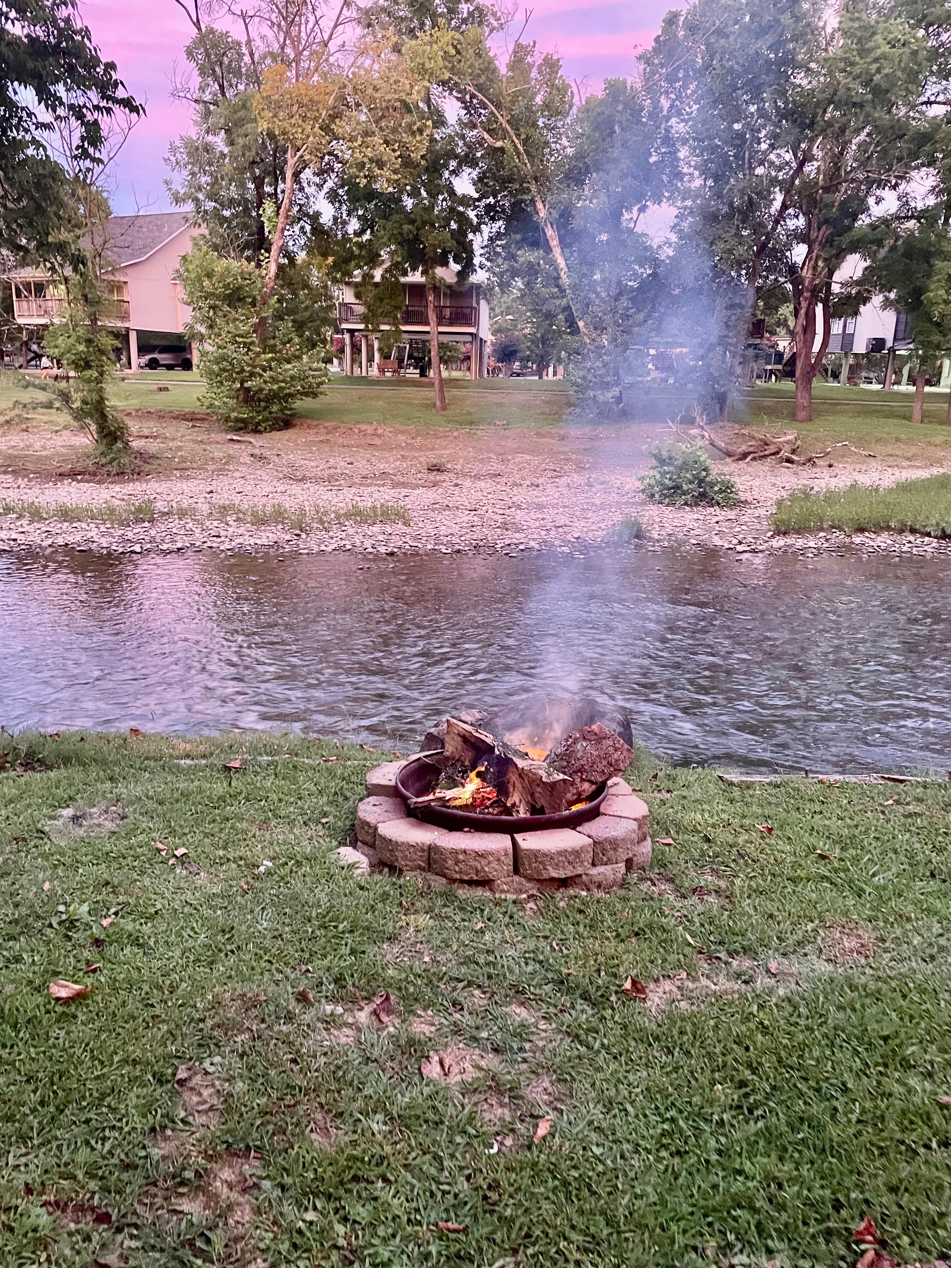 Cotton Candy skies by the river with a fire