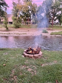 Cotton Candy skies by the river with a fire