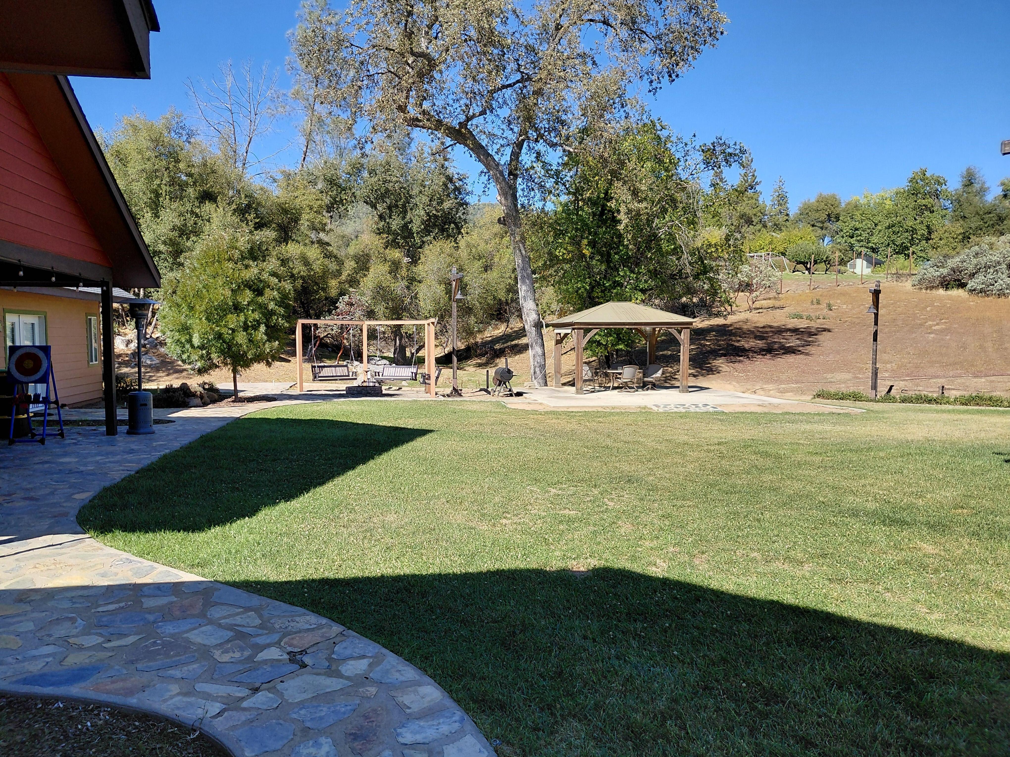 big backyard with fire pit and swing. Enjoy the great outdoors.