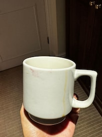 Dirty cup with tea and lipstick stains