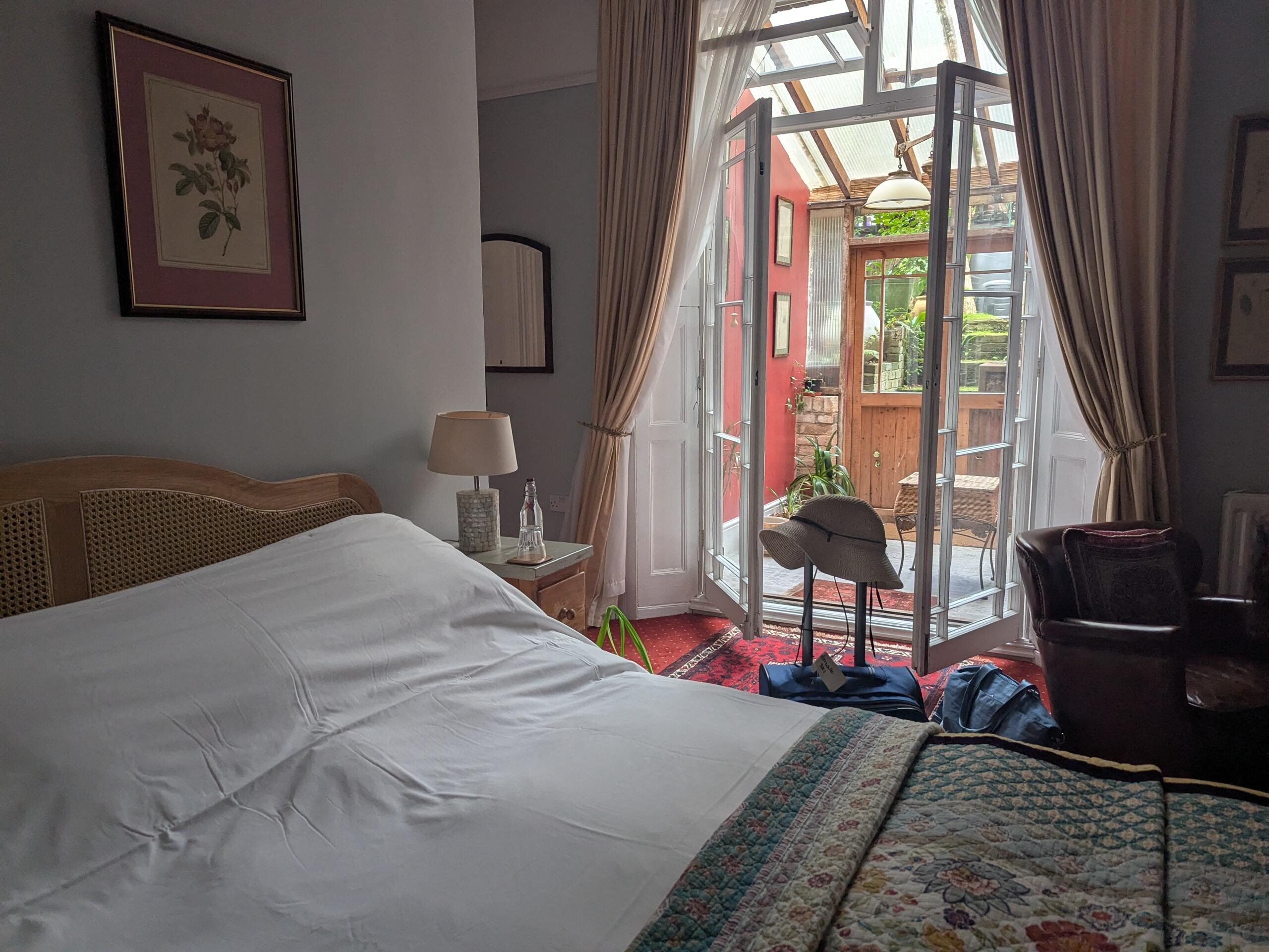 Very comfortable bed with little water bottles and glasses refilled each day. The bedroom opens to a private sunroom.