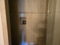 Large walk in shower with bench