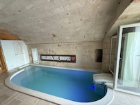 Indoor heated pool with different colorful lights and jets.