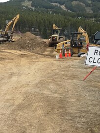 Directly, adjacent to house property, dump trucks back and forth in front of home. Workers all around and fumes all around. Not the dream vacation