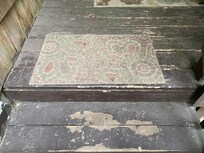 Back deck with dirty carpet.