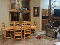 Dining room table for six, there is also four bar stools.