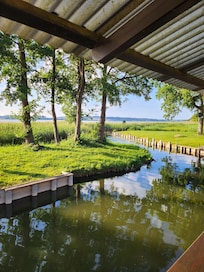 Blick vom Balkon auf dem Wasserweg für das Ruderboot zum See.