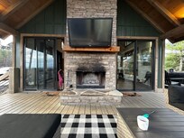 Deck/Porch fireplace. Sliding doors in to living area on either side.