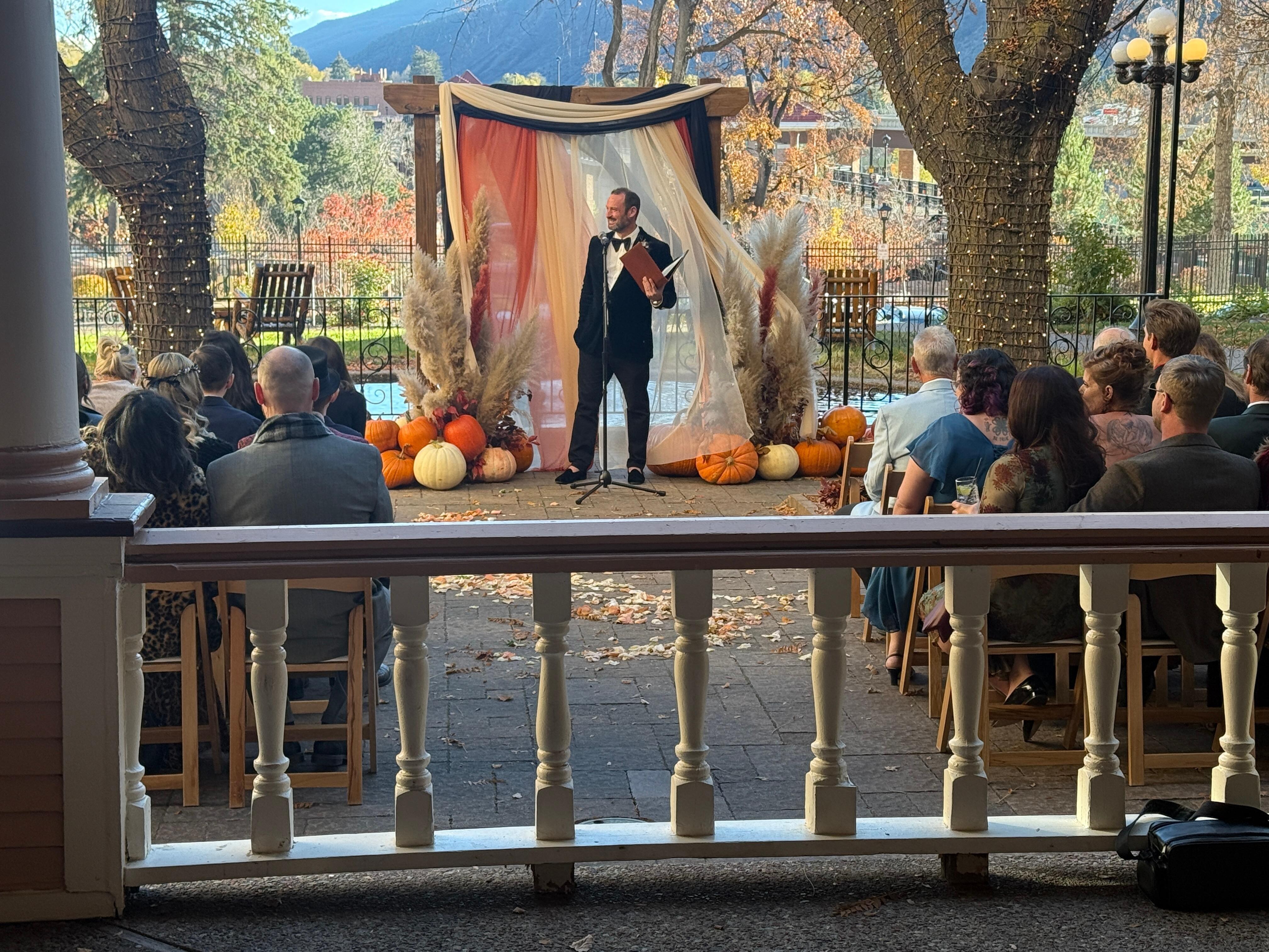 A Halloween themed wedding taking place. People look like they were having a lot of fun.